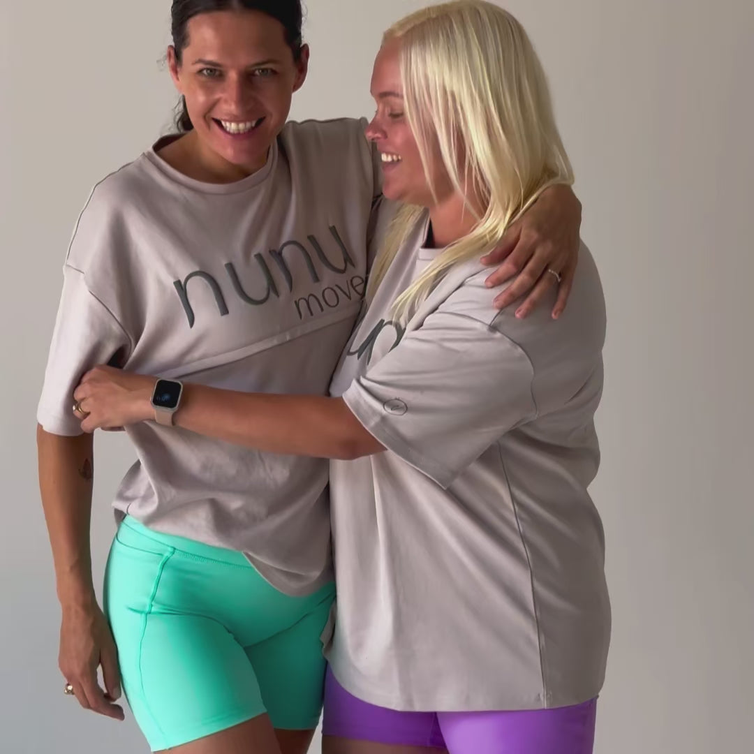 Video montage demonstrating the convenience and versatility of Nunu Move breastfeeding activewear. Clips show two mums demonstrating the quick-zip access of the Oversized Nursing Tee, a mum pumping hands-free in the Clover bra, a mum breastfeeding while doing floor exercises, and a mum holding a baby while laughing.